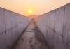 Dismantled drain showing finished concrete surface with sunset in the background