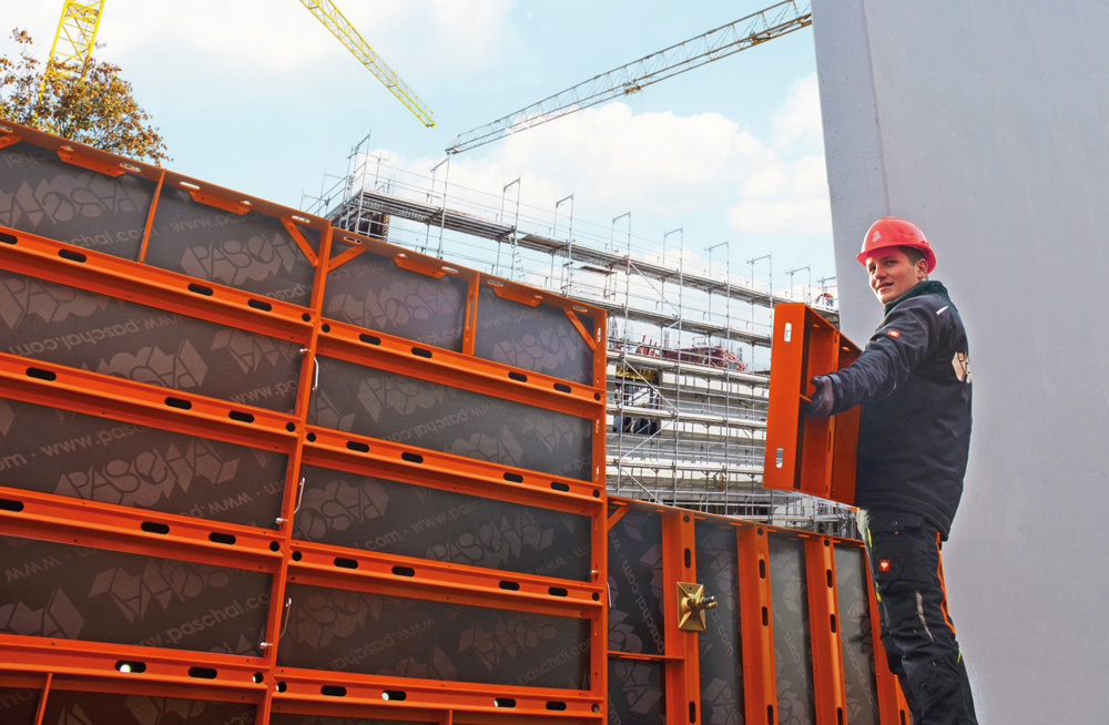 Man carrying NeoR formwork panel on the construction site