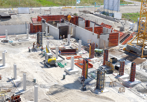 View to construction site with cranes and formwork